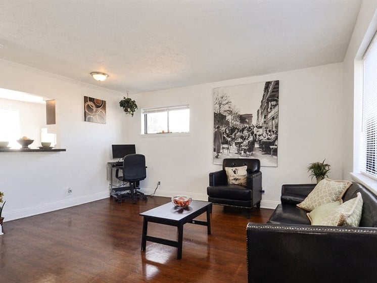 Living room features hardwood floor in apartment at Pangea Vistas in Indianapolis.